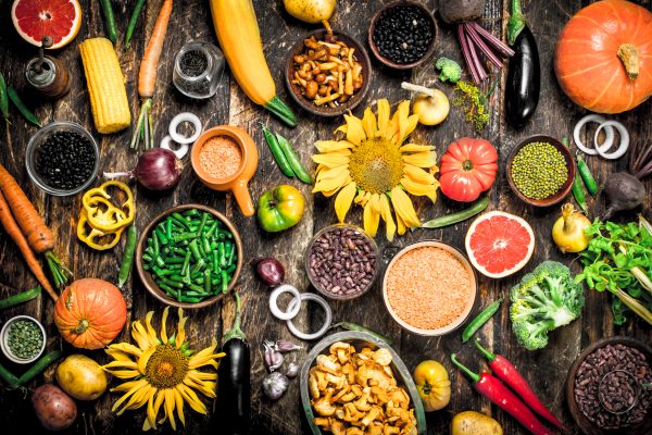 Organic food. A variety of vegetables and fruits. On a wooden background.